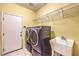 Functional laundry room equipped with a washer, dryer, and utility sink at 5480 Oatfield St, North Las Vegas, NV 89081