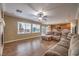 Open-concept living room with hardwood floors and view of the backyard at 5480 Oatfield St, North Las Vegas, NV 89081