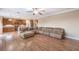 Open concept living space with hardwood floors and a large sofa at 5480 Oatfield St, North Las Vegas, NV 89081