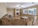 Spacious living room with a fireplace, large sectional, and abundant natural light at 5480 Oatfield St, North Las Vegas, NV 89081