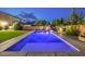 A backyard swimming pool has concrete decking, privacy walls, and green grass near the house at 5480 Oatfield St, North Las Vegas, NV 89081