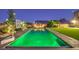 Stunning pool with water features, basketball hoop, privacy landscaping, and covered automatic pool cover at 5480 Oatfield St, North Las Vegas, NV 89081