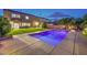 Backyard with an in-ground pool, a large green lawn, and an outdoor dining area at 5480 Oatfield St, North Las Vegas, NV 89081