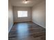 Bedroom featuring modern hardwood flooring with light filtering window at 5509 Big Sky Ln, Las Vegas, NV 89149