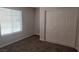 Carpeted bedroom featuring a window for natural light and a double-door closet at 5509 Big Sky Ln, Las Vegas, NV 89149