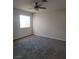 Neutral bedroom featuring plush carpeting, ceiling fan, and natural light from the window at 5509 Big Sky Ln, Las Vegas, NV 89149