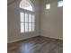 Well lit living room featuring wood flooring and light filtering shutters at 5509 Big Sky Ln, Las Vegas, NV 89149