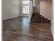 Bright and spacious living room with new flooring, large windows, and a staircase at 5509 Big Sky Ln, Las Vegas, NV 89149