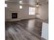 Open living area featuring wood floors, ceiling fan, fireplace, and storage at 5509 Big Sky Ln, Las Vegas, NV 89149