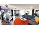 Open concept living room featuring an orange rug and uniquely modern furnishings at 5817 Rae Dr, Las Vegas, NV 89108