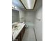 Bathroom with white tile floors, a vanity, and a tub with a shower at 600 Woodmount Dr, Las Vegas, NV 89107