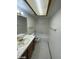 Bathroom with white tile floors, a vanity, and a tub with a shower at 600 Woodmount Dr, Las Vegas, NV 89107