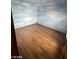Bedroom features faux-painted sky walls and wood floors at 600 Woodmount Dr, Las Vegas, NV 89107