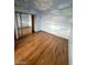 Bedroom featuring faux-painted sky walls, wood floors and closet with mirrored doors at 600 Woodmount Dr, Las Vegas, NV 89107