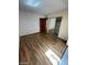 A bedroom featuring wood floors and a closet with mirrored sliding doors at 600 Woodmount Dr, Las Vegas, NV 89107