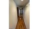 Narrow hallway with wood flooring and access to other rooms at 600 Woodmount Dr, Las Vegas, NV 89107
