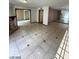 Open-concept living room featuring tile flooring and brick fireplace at 600 Woodmount Dr, Las Vegas, NV 89107