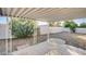 Covered patio with an adjacent backyard featuring mature landscaping at 6143 Basilone Ave, Las Vegas, NV 89122