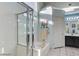 Bright bathroom with a glass-enclosed shower, soaking tub, and double sink vanity at 6143 Basilone Ave, Las Vegas, NV 89122