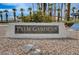 Community sign for Palm Gardens in a community featuring lush palm trees and greenery at 6143 Basilone Ave, Las Vegas, NV 89122