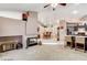Spacious living room with a cozy fireplace, open floor plan, and seamless flow to the kitchen at 6143 Basilone Ave, Las Vegas, NV 89122