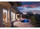Luxurious backyard with pool, spa, brickwork, and covered patio perfect for entertaining or relaxation with a sunset view at 64 Tapadero Ln, Las Vegas, NV 89135