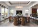 Elegant dining room with a modern chandelier, a large table, and seamless access to the backyard at 64 Tapadero Ln, Las Vegas, NV 89135