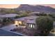 Attractive single-story home with desert landscaping, featuring a three-car garage and mountain views at 64 Tapadero Ln, Las Vegas, NV 89135