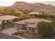Beautiful single-story home with a brick driveway and desert landscaping against a mountain backdrop at 64 Tapadero Ln, Las Vegas, NV 89135