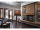 Inviting living room with a fireplace, comfortable seating, and bar area at 64 Tapadero Ln, Las Vegas, NV 89135