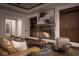Cozy living room includes built-in shelving, a stone fireplace, and comfortable seating arrangements at 64 Tapadero Ln, Las Vegas, NV 89135