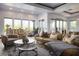 Bright and airy living room boasts stylish furnishings, large windows, and seamless outdoor access at 64 Tapadero Ln, Las Vegas, NV 89135