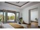 Spacious main bedroom with doors leading to the backyard and pool area at 64 Tapadero Ln, Las Vegas, NV 89135