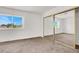Bright bedroom showcasing a large window and mirrored closet doors at 6445 Ironbark Ln, Las Vegas, NV 89107