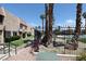 Community pool area with palm trees and landscaped grounds, surrounded by residences at 6445 Ironbark Ln, Las Vegas, NV 89107