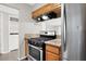 Well-lit kitchen featuring stainless steel appliances and stone countertops at 6445 Ironbark Ln, Las Vegas, NV 89107