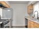 Bright kitchen showcasing wood cabinetry and stainless steel refrigerator at 6445 Ironbark Ln, Las Vegas, NV 89107