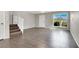Open living area with wood-look tile flooring, stairs, and natural light at 6445 Ironbark Ln, Las Vegas, NV 89107