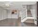 Open-concept living room with staircase and views to kitchen, and modern flooring at 6445 Ironbark Ln, Las Vegas, NV 89107