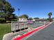 Exterior view of the parking area and surrounding green space and mailboxes at 6445 Ironbark Ln, Las Vegas, NV 89107