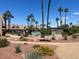 Community pool area surrounded by lush landscaping and walkways at 6445 Ironbark Ln, Las Vegas, NV 89107