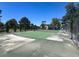 Outdoor community tennis court surrounded by mature landscaping and fencing at 6445 Ironbark Ln, Las Vegas, NV 89107