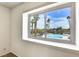 Window view of a community pool and palm trees, offering a relaxing vista at 6445 Ironbark Ln, Las Vegas, NV 89107