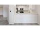 Bright kitchen featuring white cabinets, stainless steel appliances, and modern countertops at 6871 Tamarus St # 204, Las Vegas, NV 89119