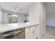 The kitchen features light countertops, white cabinets, and stainless steel appliances at 6871 Tamarus St # 204, Las Vegas, NV 89119