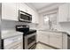This modern kitchen has stainless steel appliances, light countertops, and white cabinets at 6871 Tamarus St # 204, Las Vegas, NV 89119
