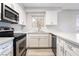Bright kitchen featuring white cabinets, stainless steel appliances, and light countertops at 6871 Tamarus St # 204, Las Vegas, NV 89119