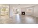 Spacious living room boasts a fireplace, wood floors, and access to a balcony at 6871 Tamarus St # 204, Las Vegas, NV 89119