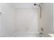 Bright bathroom tub featuring white tiled walls, and a shower head at 6871 Tamarus St # 204, Las Vegas, NV 89119