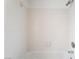Close up of a bright bathroom tub with white tiled walls, and a shower head at 6871 Tamarus St # 204, Las Vegas, NV 89119